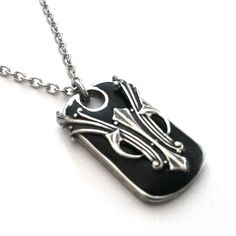 This sophisticated yet edgy necklace features a rounded rectangular stainless steel pendant filled with black resin, adorned with an intricate medieval warrior symbol. With dimensions of 1.5" tall x .75" wide x .25" deep, it's a great size for a man or woman. Each pendant is handmade in the US and ships in a jewelry box, making it an ideal gift for any occasion. Black Engraved Rectangular Pendant Necklaces, Black Engraved Rectangular Pendant Necklace, Black Pewter Jewelry As A Gift, Medieval Black Metal Necklace, Medieval Style Black Metal Necklace, Black Gothic Necklace With Soldered Details, Gothic Engraved Black Jewelry, Black Engraved Rectangular Pendant Jewelry, Gothic Black Engraved Jewelry