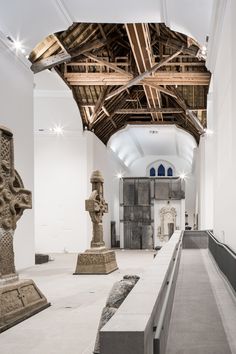 the interior of an art museum with sculptures on either side of the wall and ceiling