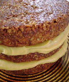 there is a cake that has been frosted with white icing on it and sits on a plate