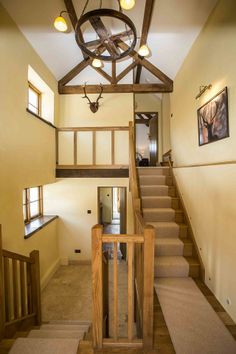 a staircase leading up to the second floor in a home with wood and stone accents