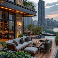 an outdoor living area with couches, tables and chairs overlooking the cityscape