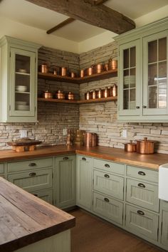 a kitchen with green cabinets and wooden counter tops