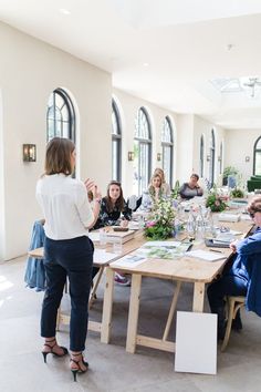 a group of people sitting around a wooden table