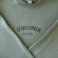 Virginia Embroidered Sweatshirt, Virginia Sweatshirt, State Virginia Crewneck, Embroidered Crewneck Sweatshirts, Green, Long Sleeve We offer a variety of custom made embroidery apparel.   See photos above for size and color options.   Our crewneck sweatshirts and hoodies come in  size S - 2XL. Please choose from the dropdown menu what size and color you'd like.  In the notes at checkout, please let me know the thread colors you'd like on your clothing, otherwise, it will be made like the photo. Green Embroidered Sweatshirt, Casual Crew Top With Machine Embroidery, College Long Sleeve T-shirt With Machine Embroidery, Long Sleeve Embroidered College T-shirt, Long Sleeve Embroidered T-shirt For College, Machine Embroidered Crew Neck Top For College, Casual Green Sweatshirt With Embroidery, Crew Neck Top With Machine Embroidery For College, Green Crew Neck Sweatshirt With Machine Embroidery