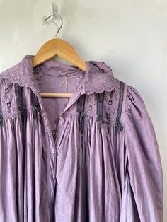 Vintage Victorian Overdyed Purple Dress. Lace-trimmed dress with bow details and puffy sleeves that make you feel like you're in a haunted 1920s mansion. The collar has black details that bring out the lacey designs. In good vintage condition with a few missing buttons (sold as is). Fits like a S/M. Feels like cotton/linen. Approx. Measurements: Underarm to underarm: 18" Length: 55" Vintage Lace Trim Dresses For Loungewear, Long Sleeve Victorian Dress With Lace Trim For Daywear, Fitted Long Sleeve Vintage Nightgown, Daywear Victorian Dress With Lace Patchwork, Vintage Fitted Long Sleeve Nightgown, Long Sleeve Lace Trim Dress For Night, Long Sleeve Dresses With Lace Trim For Night, Vintage Dresses For Spring Night, Vintage Night Dresses For Spring