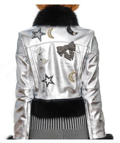 Galactic Lady: one of our first jackets, was designed to be girly, yet edgy with a burst of metallic and hints of sparkle. The Mini in Silver Metallic Leather is complimented by removable soft black fur. All fur is eco-fur sourced from New Zealand and dyed locally in New York City.  Size Medium - Sample Sale - Price without fur is:  $295 - Please contact seller if you would like to purchase without the fur. Item can be sold without fur; it is removable without any damage to the jacket. Attached by snap buttons. Luxury Metallic Outerwear For Evening, Luxury Embellished Winter Outerwear, Luxury Metallic Party Outerwear, Luxury Silver Outerwear For Parties, Chic Winter Evening Biker Jacket, Luxury Metallic Outerwear, Winter Embellished Leather Jacket With Long Sleeves, Luxury Party Outerwear With Faux Fur Trim, Winter Embellished Long Sleeve Biker Jacket