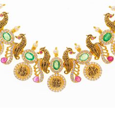 This extravagant 22k yellow gold and gemstone necklace set features exquisite elements and details that are simply breathtaking. The beautiful emeralds, rubies, and cubic zirconia decorating engraved depictions of deities and seahorses give this 22k temple jewelry necklace and earring set a dazzling appeal.Features• 22k yellow gold• Emerald• Ruby• Cubic zirconia• Deities• SeahorsesVirani Jewelers bridal jewelry made from 22k gold brings together the beauty and significance of Indian culture and Kasu Necklace, Indian Culture And Tradition, Temple Jewelry Necklace, Temple Jewelry, Gold Jewelry Sets, Gold Bead Necklace, Indian Culture, Seahorses, Bridal Jewellery Indian