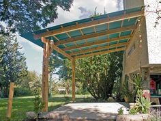 an outdoor covered patio with trees and plants