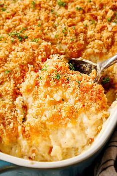 a casserole dish filled with macaroni and cheese, garnished with parsley