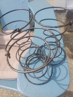 several metal rings sitting on top of a blue bench