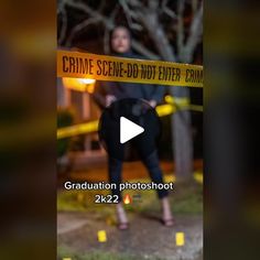 a woman standing in front of a yellow caution tape