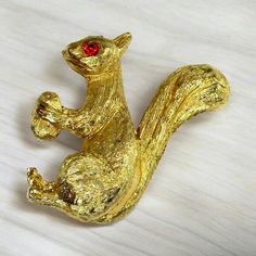 Vintage 1980s Squirrel Brooch Gold Tone Metal with Red Rhinestone Eye  Nice piece of Costume Jewelry. In very nice preowned condition Measures 1.5 inches long Eye Costume, Squirrel Jewelry, Vintage Squirrel, Red Rhinestone, An Eye, Gold Tone Metal, Costume Jewelry, Labour Day, Brooch Pin