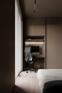 a bedroom with a bed, desk and chair next to a wall that has built - in shelving