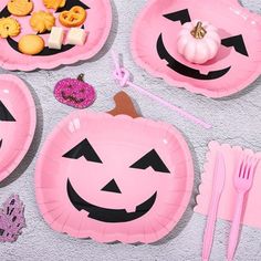 pink paper plates with pumpkin faces on them and other items to make it look like they are