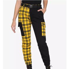 No Longer Sold On Website Your Cargo Joggers Just Got A Whole Lot Edgier! This Pair Of Joggers Is Split Down The Middle, Half Solid Black And Half Yellow Plaid, With Contrasting Utility Pockets On Both Sides. Comes With Hip Pockets And A Removable Utility Buckle Belt. Elastic Waistband And Ankle Cuffs. 98% Cotton; 2% Spandex Wash Cold; Dry Low Rise: 11" Inseam: 27 1/2" Leg Opening: 5" Imported Listed In Junior Sizes Reasonable Offers Are Welcome Additional Photos/Measurements Upon Request Ships Emo Sanrio, Utility Buckle, Victorious Secret, Anime Gamer, Tripp Pants, Androgynous Outfits, Cargo Jogger Pants, Yellow Clothes, Black Punks