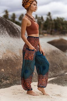 Teal and peach boho trousers with mandala pattern * Made from 100% rayon * Lightweight and comfortable * Elasticated ankles and waistband   * Small Length - 40"/ 100cm Waist - 22"/ 57cm - 44"/ 111cm * Medium/Large Length - 40"/ 101cm Waist - 30"/ 76cm - 53"/134cm * Small fit most UK ladies size 6-10 (US 2-6) * Medium/Large fit most UK ladies 12-16 (US 8-12) Bohemian Summer Harem Pants With Pockets, Hippie Boho Print Vacation Bottoms, Bohemian Harem Pants With Pockets For Summer, Summer Hippie Pants With Boho Print, Bohemian Bottoms With Pockets For Vacation, Boho Print Hippie Pants For Vacation, Hippie Boho Print Pants For Vacation, Boho Print Harem Bottoms For Summer, Boho Print Harem Pants For Summer Vacation