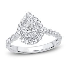 a white gold ring with diamonds on the band and a pear shaped diamond in the center