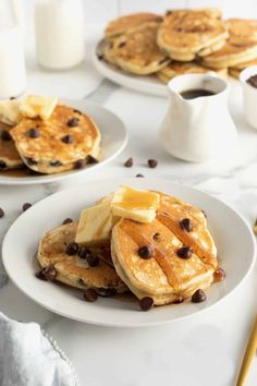 pancakes with chocolate chips and butter on white plates