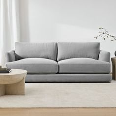 a living room scene with focus on the couch and coffee table in the foreground