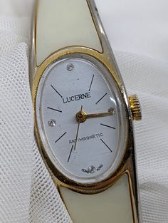 Vintage LUCERINE Ladies Watch WIND-UP hinged band - Hong Kong 1970's Working. Good condition, working wind-up mechanical watch. Gold/white colored plastic opening band suits a smaller wrist; 16cm to 18cm wrist / white colored dial. Crystal has some light scratches, see pictures. PLEASE NOTE! Very old watches and clocks, especially the wind-up mechanical type, are notoriously unreliable and temperamental. Although they may be listed as 'working' this does not mean that they can be relied on like White Retro Watch For Formal Occasions, Retro White Watches For Formal Occasions, White Retro Formal Watch, White Retro Formal Watches, Vintage White Watch Accessories With Round Dial, Vintage White Round Dial Watch Accessories, Vintage White Analog Watch, Vintage White Automatic Watch Accessories, Luxury Collectible Manual Winding Watches