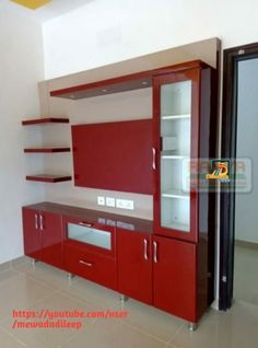 an empty kitchen with red cabinets and white walls