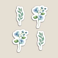 four stickers with blue flowers and leaves in the shape of heart, leaf, flower