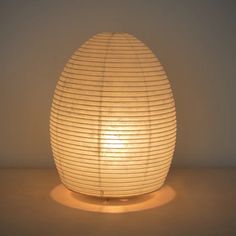 an egg shaped lamp sitting on top of a table