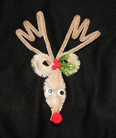 a reindeer head made out of felt with red nose and green leaves on it's antlers