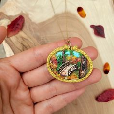 This hand-sculpted pendant is unique, handmade, and one of a kind. Perfect for nature lovers who want a statement piece that is both whimsical and sophisticated.  It is made of 100% polymer clay, with each piece carefully sculpted to create a painting. SIZE The pendant is about 1.5 inches in height and 1.75inches wide.  The necklace chain is adjustable between 16-19 inches. MATERIALS Made from polymer clay.   Each piece is unique and lovingly made by hand, so please allow slight imperfections in Bohemian Handmade Jewelry For Keepsake, Handmade Nature-inspired Necklace For Gift, Nature-inspired Round Jewelry For Crafting, Nature-inspired Jewelry With Unique Variations As Gift, Nature-inspired Round Pendant Jewelry For Crafting, Handmade Artisan Resin Jewelry, Custom One Of A Kind Pendant Necklace, Handmade Round Nature-inspired Necklaces, Artisan Pendant Necklace As Gift