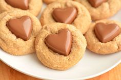 heart shaped cookies on a plate with chocolate