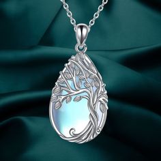 The Tree of Life Necklace is a powerful symbol representing positive energy, growth, strength, rebirth, longevity, good health, and new beginnings. This unique necklace features a tree of life pendant inlaid with moonstone, giving it a mysterious, elegant, and charming quality. Made of high-quality 925 sterling silver, this necklace is hypoallergenic, tarnish-resistant, nickel-free, lead-free, and cadmium-free, making it suitable for long-term wear, especially for those with sensitive skin. The teardrop pendant measures 0.54 by 1.13 inches and comes with an 18-inch chain with a 2-inch extension. It is elegantly packaged in a gift box, making it a perfect choice for birthday, congratulatory, or anniversary gifts for women, men, best friends, wives, lovers, grandmas, mothers, and more. Nature-inspired Silver Necklace For Meditation, Nature-inspired Silver Meditation Necklace, Silver Tree Of Life Necklace For Healing, Spiritual Silver Teardrop Crystal Necklace, Silver Teardrop Pendant Necklace Nature-inspired, Silver Nature-inspired Teardrop Pendant Necklace, Doctor Jewelry, Cremation Bracelet, Urn Bracelet