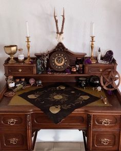 an antique desk with various items on it