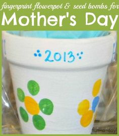 a cup with flowers painted on it and the words happy mother's day written in blue