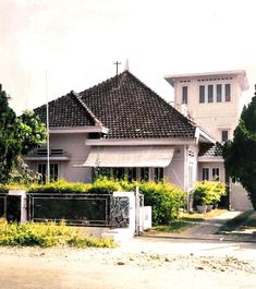 a large white house sitting on the side of a road