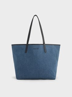 Denim Blue Sianna Denim Reversible Tote Bag | CHARLES & KEITH Luxury Blue Coated Canvas Shoulder Bag, Luxury Everyday Denim Blue Bags, Luxury Denim Blue Leather Bag, Cheap Reversible Blue Bags, Affordable Blue Tote Bucket Bag, Luxury Denim Blue Shoulder Bag For Shopping, Luxury Denim Blue Bags For Everyday, Luxury Denim Blue Shoulder Bag With Removable Pouch, Luxury Denim Blue Bag With Zipper Closure