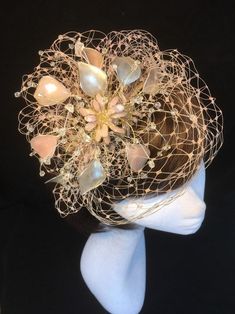 Pale pink, ivory and gold fascinator perfect for the bride or guest who wants something beautifully unique and bespoke. This design is a stunning selection of glass effect leaves and flowers clustered together amongst a fine layer of veiling and set onto a fine comfort tiara band. As with all our designs, this piece can be made exact to the image or in any colour combination to match in with your outfit. If a specific colour is required customers can message over an image of their outfit and acc Elegant Cream Party Veil, Wedding Costume Hats And Headpieces With Handmade Flowers, Handmade Gold Hair Accessories For Wedding, Pink Wedding Fascinator Headband, Handmade Pinched Crown Hat For Wedding, Pink Wedding Hat Hair Accessories, Elegant Handmade Wedding Costume Hats And Headpieces, Elegant Handmade Wedding Costume Hats, Handmade Pinched Crown Fascinator For Wedding