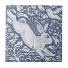 a blue and white tile with an image of a rabbit