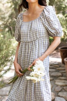 Embrace effortless comfort with our Maddie Dress, featuring a playful gingham print and a roomy, flowy fit that flatters every body type. The super stretchy neckline, perfect for nursing moms, allows for versatile styling, while the fully lined design ensures confidence and comfort. Perfect for any occasion, from sunny picnics to casual outings, this dress effortlessly combines vintage appeal with modern ease. Available in sizes XS to XXL, it's your go-to choice for chic, carefree style. Monteci Farmhouse Dresses, Feminine Homemaker, Homemaker Dress, Carefree Outfits, Rome Clothes, Homemaker Fashion, Grandma Core Fashion, Sister Missionary Dresses, Mormon Dress