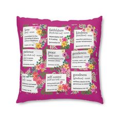 a pink pillow with flowers and words on the front, which are in different languages