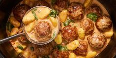 a pot filled with meatballs and potatoes