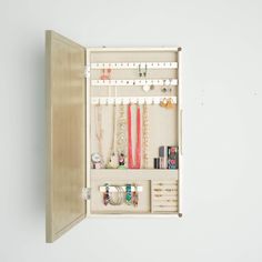 PRICES MAY VARY. Wall hanging jewelry storage mirror Storage options include 25 earring hooks, 10 necklace hooks, 7 divided compartments, a bracelet bar and ring rolls The inside is lined with a anti-tarnish linen Easy opening access design Includes mounting hardware Item Dimensions 3. 2 x 13. 5 x 24 inches Apartment Closet, Hanging Jewelry Storage, Jewlery Holder, Champagne Jewelry, Mirror Jewellery Cabinet, Jewelry Organizer Wall, Jewelry Wall, Hanging Jewelry Organizer, Jewelry Organizer Storage