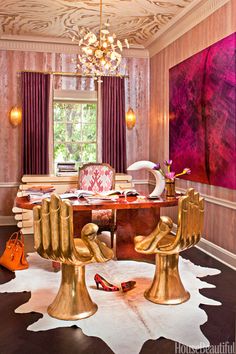 a room with pink and gold decor in the corner, including a chandelier