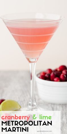 cranberry and lime metropolita martini in a coupe glass next to a bowl of cranberries