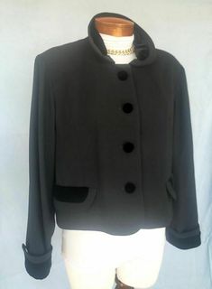 SAKS FIFTH AVENUE Fashion Jacket Sz 14 BLACK 4 Buttons Velvet Trim ELEGANT Classic Description DESIGNER -  Saks Fifth Avenue   SORRY THE PICTURES ARE HARD TO SEE...IT'S SO NICE   STYLE -  This is a lovely 4 button jacket from SFA....it has velvet trim at the collar, cuffs, and buttons and is very pretty on!   COLOR -  Black with black trim   CONDITION -  Great   FABRIC - Polyester   SIZE - 14   MEASUREMENTS: Bust  44" Hipline  42" Overall Length 19"   Please e-me with questions, PayPal preferred Vintage Black Outerwear For Work, Formal Black Outerwear With Covered Buttons, Workwear Blazer With Buttons, Vintage Black Outerwear With Buttons, Black Button-up Outerwear With Covered Buttons, Black Blazer With Snap Buttons For Formal Occasions, Black Formal Blazer With Snap Buttons, Formal Black Blazer With Snap Buttons, Black Vintage Outerwear With Button Closure