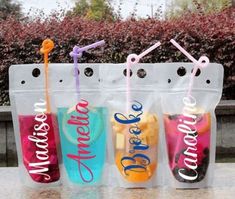 three plastic bags filled with different types of fruit and drink in front of a tree