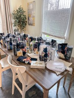 a long table with many bags on it and some chairs in front of the table