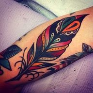 a colorful feather tattoo on the arm