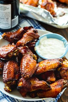 some chicken wings on a plate with ranch dressing