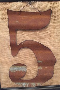 the number five is made out of wood and burlied with jute fabric