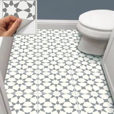 a bathroom with a white toilet next to a black and white tile floor in it